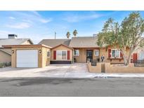 Charming single-story home featuring a well-manicured lawn and a freshly painted facade at 5005 Harmony Ave, Las Vegas, NV 89107