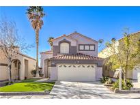Charming two-story home featuring a well-maintained lawn and a two-car garage in a residential neighborhood at 7267 Sequoia Springs Dr, Las Vegas, NV 89147