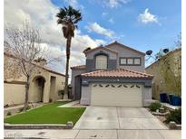 Charming two-story home with a well-manicured lawn, tile roof and desert landscaping at 7267 Sequoia Springs Dr, Las Vegas, NV 89147
