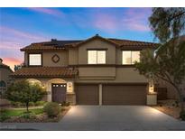 Charming two-story home features a well-maintained front yard and attached two-car garage at 820 Sandhill Sage St, Henderson, NV 89052