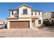Charming two-story home with desert landscaping, a brown garage door, and a cute second story balcony at 8237 New Leaf Ave, Las Vegas, NV 89131