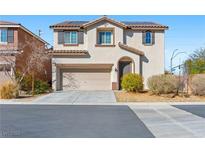 Two-story home with stucco siding, desert landscaping, and a two-car garage at 8620 Abbey Dell Ave, Las Vegas, NV 89178