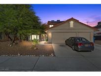 Charming two-story home featuring a well-manicured front yard, mature trees, and a spacious two-car garage at 8912 Dio Guardi Dr, Las Vegas, NV 89117