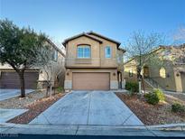 Two-story home featuring neutral toned stucco, a two-car garage and manicured front yard landscaping at 8149 Sandy Slope Ct, Las Vegas, NV 89113