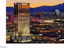 Illuminated Las Vegas cityscape featuring the Trump hotel set against a backdrop of mountains at twilight at 2000 N Fashion Show Dr # 4722, Las Vegas, NV 89109