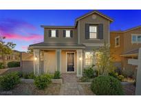 Inviting two-story home with manicured front yard landscaping and a charming covered entry at 2300 Trasimeno Pl, Henderson, NV 89044