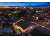 Expansive aerial view showcases a Las Vegas home with a private pool at twilight at 3057 Downing Pl, Las Vegas, NV 89121