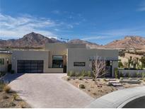 Modern home showcasing desert landscaping and mountain views under a bright, cloudy sky at 333 Highview Ridge Ave, Las Vegas, NV 89138