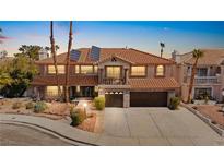 Two-story home featuring a red tile roof, neutral stucco, and a spacious three-car garage at 3620 Bahama Bay Ct, Las Vegas, NV 89147