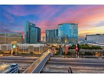 Striking cityscape view showcasing illuminated buildings, a vibrant sunset, and busy streets below at 4575 Dean Martin Dr # 3009, Las Vegas, NV 89103