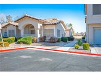 Inviting one-story home featuring desert landscaping, an arched entryway, and neutral paint colors at 4980 Black Bear Rd # 104, Las Vegas, NV 89149