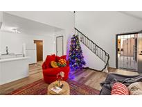 Bright living room features wood floors, staircase, and modern decor at 5166 Gray Ln # L, Las Vegas, NV 89119