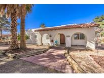 Charming arched entrance with a red-tiled roof and tiled walkway welcomes you to this cozy home at 5715 Gilbert Ln, Las Vegas, NV 89130