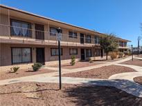 Exterior view of a two-story apartment building with walkways and simple landscaping at 615 S Royal Crest Cir # 15, Las Vegas, NV 89169