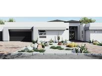 Modern home featuring desert landscaping, a brick driveway, and a black garage door, offering contemporary curb appeal at 7485 Torino Ave, Las Vegas, NV 89113