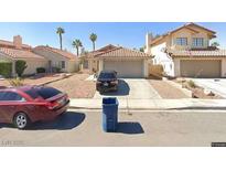 Charming single-story homes featuring desert landscaping and attached garages at 7643 Kalmalii Ave, Las Vegas, NV 89147