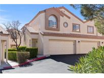 Charming two-story home with a well-maintained front yard and attached two-car garage in a suburban neighborhood at 8301 Boseck Dr # 215, Las Vegas, NV 89145