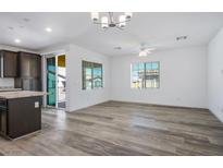 Bright living room featuring wood-look floors, recessed lights, and access to a private balcony at 965 Nevada State Dr # 39201, Henderson, NV 89002