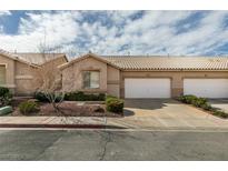 Charming single-story home featuring a two-car garage, desert landscaping, and a tile roof at 205 Crown Imperial St, Henderson, NV 89074