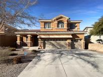 Charming two-story home featuring desert landscaping and an attached three-car garage at 2756 Blairgowrie Dr, Henderson, NV 89044