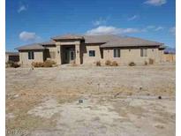 Single-story home featuring a desert landscape and a modern architectural design at 4320 Tiger Rd, Pahrump, NV 89048