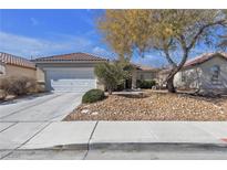 Charming single-story home with a two car garage and drought resistant landscaping at 5323 Farley Feather Ct, North Las Vegas, NV 89031