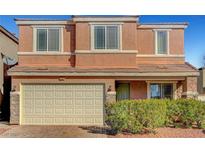 Two-story home with a neutral-toned exterior, a two-car garage, and manicured landscaping at 6190 Tillman Crest Ave, Las Vegas, NV 89139