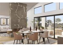 Elegant dining room with marble table, fireplace, and sliding glass doors to an outdoor space at 8825-4 S Monte Cristo Way, Las Vegas, NV 89113