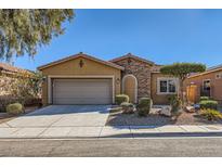 Charming single-story home featuring stone accents, desert landscaping, and an attached two-car garage at 10746 Lightning Sky St, Las Vegas, NV 89179