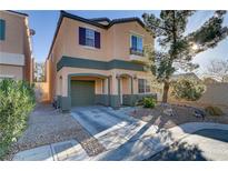 Two-story home showcasing charming curb appeal, a well-manicured front yard, and an attached one car garage at 11103 African Sunset St, Henderson, NV 89052