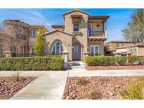 Charming two-story home with a beautiful stucco exterior and a well-maintained front yard at 11354 Merado Peak Dr, Las Vegas, NV 89135