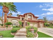 Stunning two-story home with a well-manicured front yard, stone pathway, and mature palm trees at 116 N Ring Dove Dr, Las Vegas, NV 89144