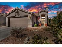 Charming home with a low maintenance yard, two car garage and sunset skies at 1842 Trigger Way, North Las Vegas, NV 89032