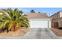 Charming single-story home featuring a two-car garage, mature landscaping, and inviting curb appeal at 1924 Falling Tree Ave, North Las Vegas, NV 89031