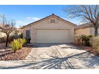 Charming single-story home featuring a well-maintained front yard and a two-car garage, all under a clear blue sky at 2137 Hidden Ranch Ter, Henderson, NV 89052
