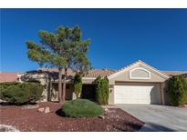 Charming single-story home with a well-manicured front yard and two-car garage at 2824 Morning Ridge Dr, Las Vegas, NV 89134