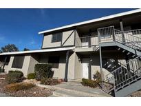 Two-story apartment building featuring a balcony and outdoor stairs at 2899 Bluebonnet Dr # 2899, Henderson, NV 89074