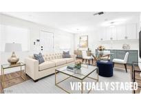 Bright living room featuring a stylish sofa, glass coffee table, and modern decor at 304 Orland St # 43, Las Vegas, NV 89107