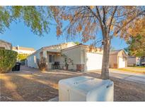 Charming single-story home with a well-maintained lawn and a detached garage at 3236 Idaho Springs St, North Las Vegas, NV 89032