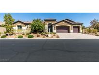 Beautiful single-story home featuring a three-car garage, desert landscaping, and a tile roof at 3914 Jacob Lake Cir, Las Vegas, NV 89118