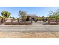 Charming home with a beautiful decorative iron gate and brick perimeter wall at 6094 S Lamb Blvd, Las Vegas, NV 89120