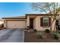 Charming single-story home featuring a two car garage, neutral stucco, and desert landscaping at 617 Abrazar Ave, North Las Vegas, NV 89081