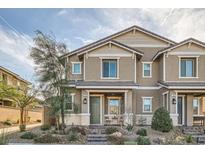 Charming two-story townhome with neutral stucco, a covered porch, and well-maintained desert landscaping at 690 Last Dance Pl, Henderson, NV 89011