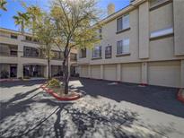 Charming condo building with well-maintained landscaping and attached garage parking at 7111 S Durango Dr # 305, Las Vegas, NV 89113