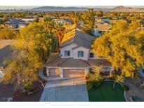 Charming two-story home with a three-car garage and a well-manicured front yard at 2204 Ambermill Ct, Henderson, NV 89052