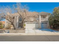 Charming two-story home with tile roof, three-car garage, and manicured landscaping at 2493 Ram Crossing Way, Henderson, NV 89074