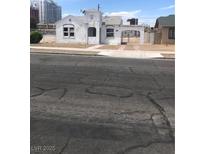 Unique home with a stucco exterior, arched entry and tower-like architectural details in a neutral palette at 309 N 9Th St, Las Vegas, NV 89101