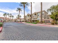 Gated Jasmine community entrance featuring lush landscaping and well-maintained buildings at 5855 Valley Dr # 2018, North Las Vegas, NV 89031