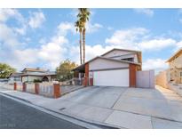 Charming single-Gathering home featuring a two-car garage, brick accents, and a well-maintained front yard at 608 Cragin Park Dr, Las Vegas, NV 89107