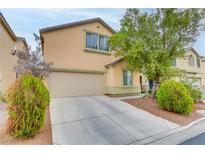 Two-story home with a two-car garage, well-kept landscaping, and a concrete driveway at 6278 Heather Creek Pl, Las Vegas, NV 89122
